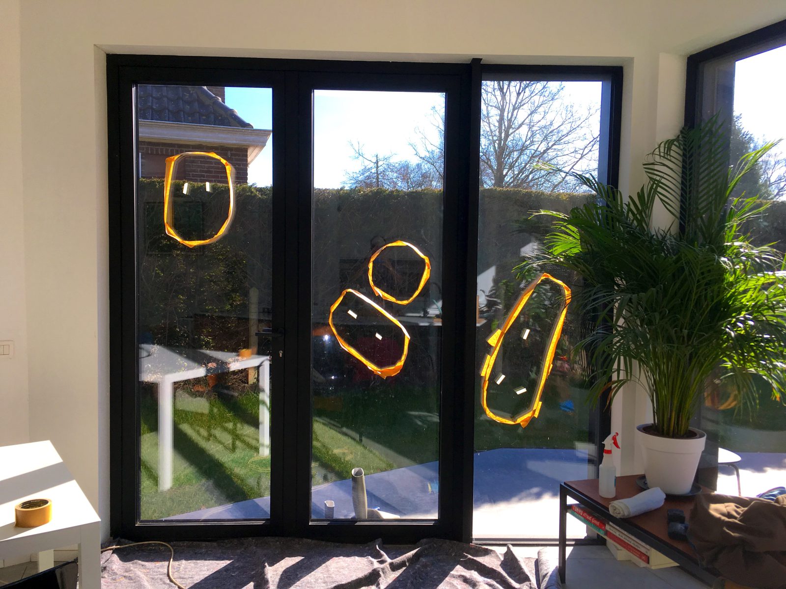 Terrasdeur van binnenuit gezien, met drie beschadigingen op het glas oranje omcirkeld